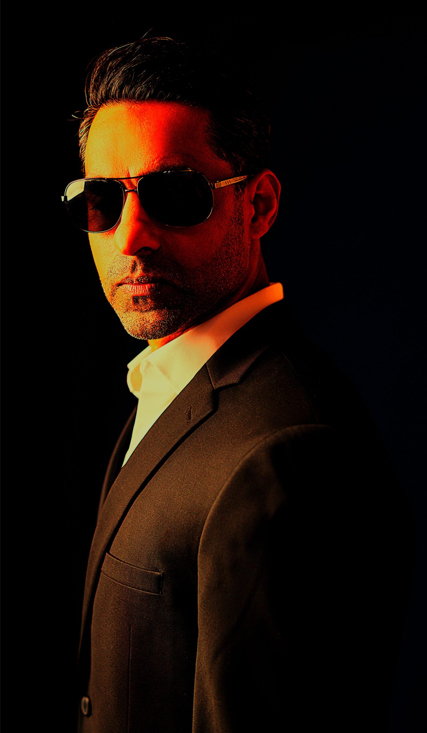 The author wearing a suit and sunglasses